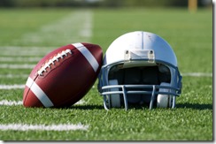 American Football and Helmet on the Field